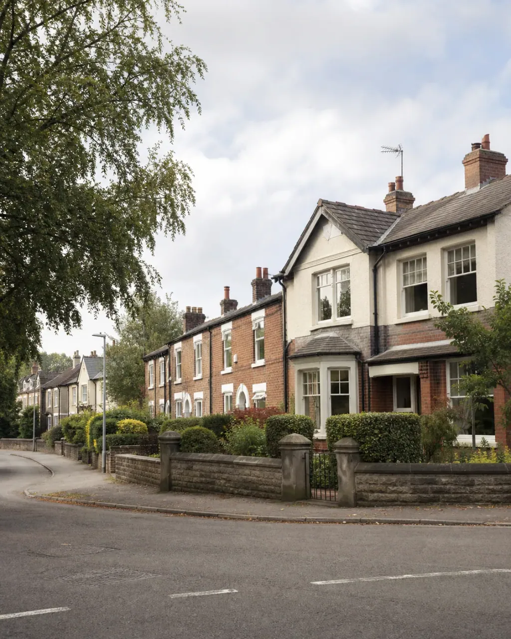 Semi-detached houses and stone garden walls on a leafy Northenden corner