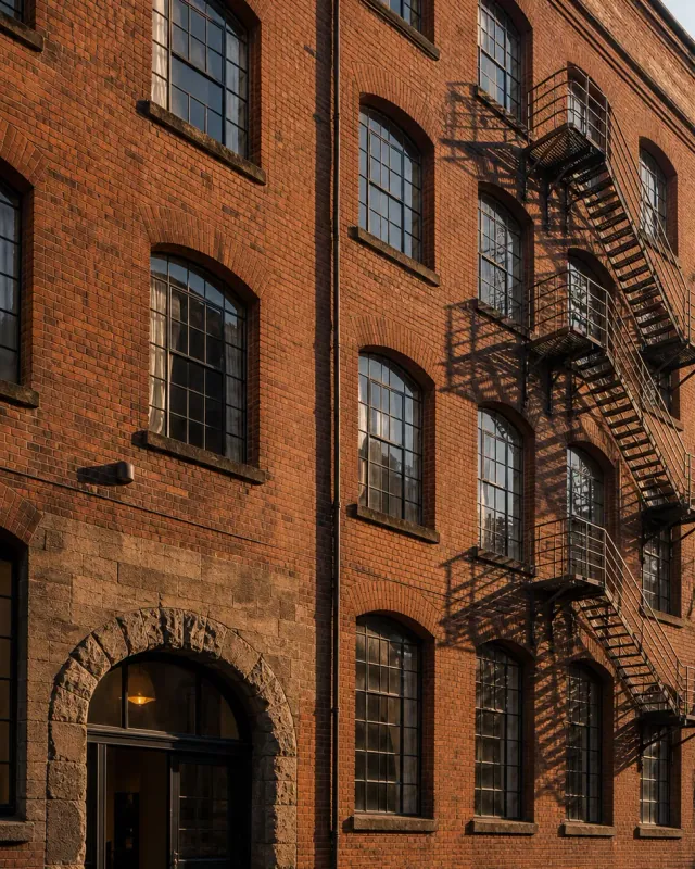 A converted red-brick warehouse with iron fire escapes in Manchester city centre