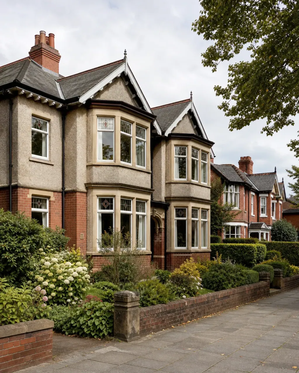 Edwardian semi-detached houses with bay windows and front gardens in Sale